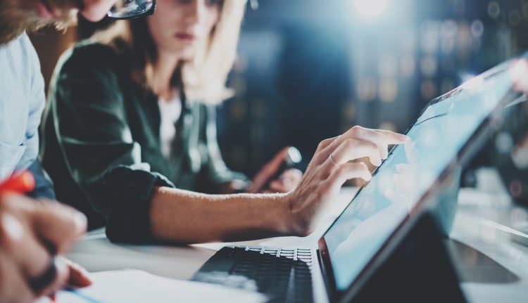 Woman pointing on digital tablet screen at bank office